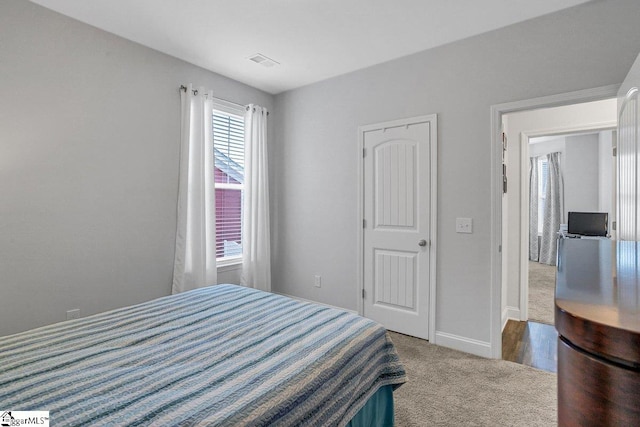 bedroom featuring carpet flooring, visible vents, and baseboards