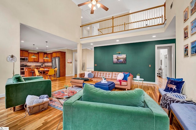 621 Shefwood Dr, Easley, SC 29642 - living area featuring baseboards, a high ceiling, crown molding, and light wood finished floors