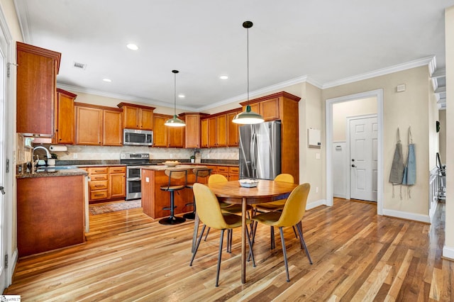 621 Shefwood Dr, Easley, SC 29642 - kitchen with stainless steel appliances, dark countertops, brown cabinets, and visible vents