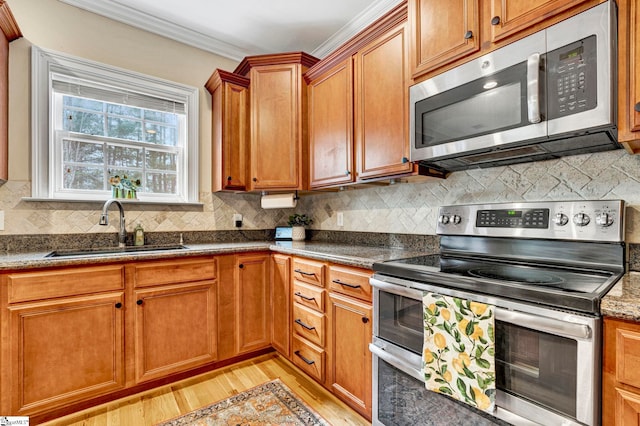 621 Shefwood Dr, Easley, SC 29642 - kitchen with backsplash, appliances with stainless steel finishes, light wood-style floors, ornamental molding, and a sink