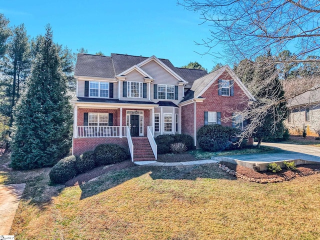 621 Shefwood Dr, Easley, SC 29642 - traditional home with covered porch, brick siding, and a front lawn