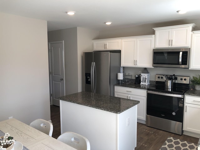 kitchen featuring stainless steel appliances, a kitchen island, and white cabinets