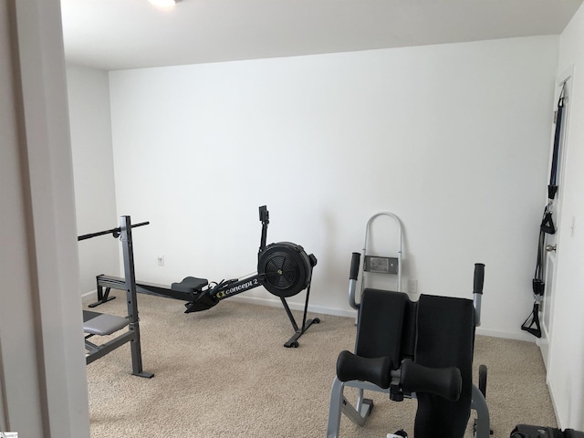 workout area featuring carpet floors and baseboards