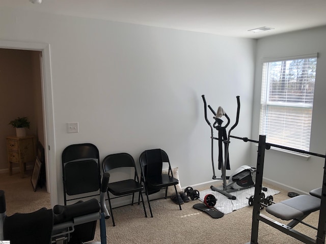 workout area featuring carpet, visible vents, and baseboards