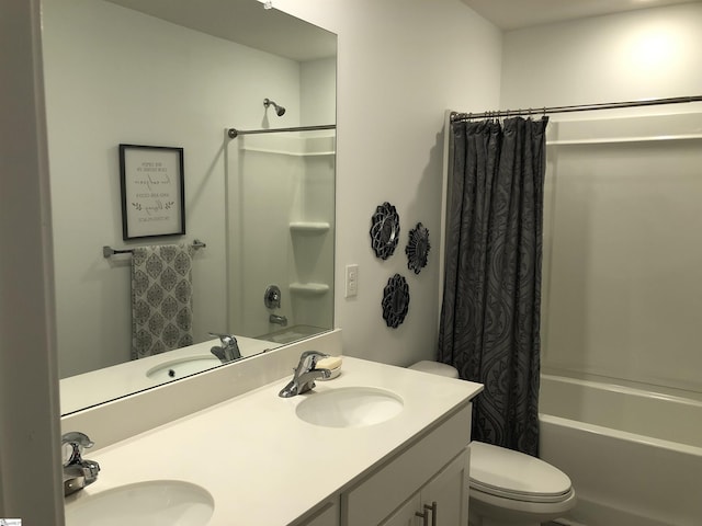 full bathroom featuring double vanity, shower / tub combo, and a sink