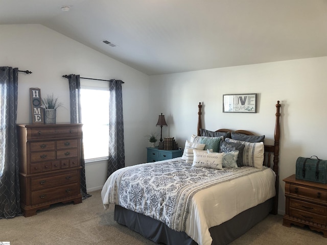 carpeted bedroom featuring lofted ceiling and visible vents