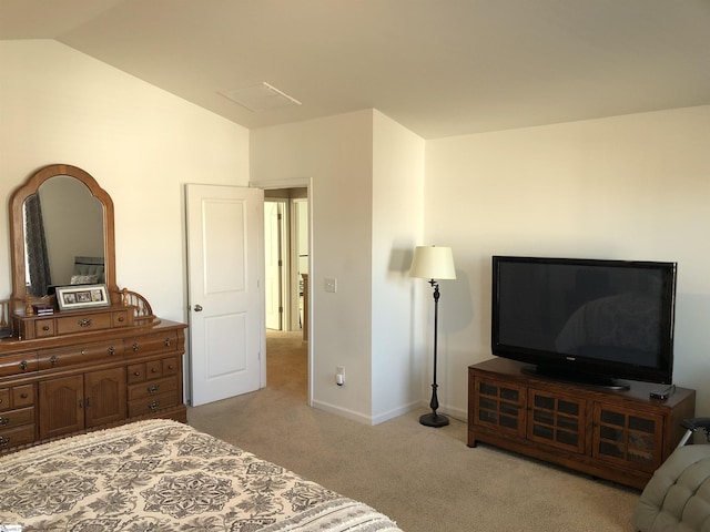 bedroom with light carpet, vaulted ceiling, and baseboards