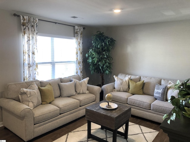 living room featuring visible vents and wood finished floors