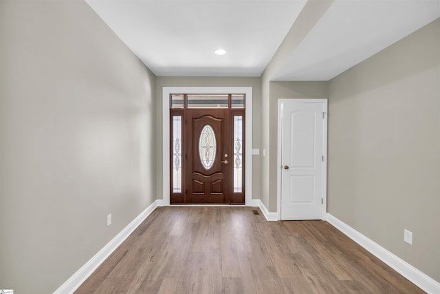 entrance foyer featuring baseboards and wood finished floors