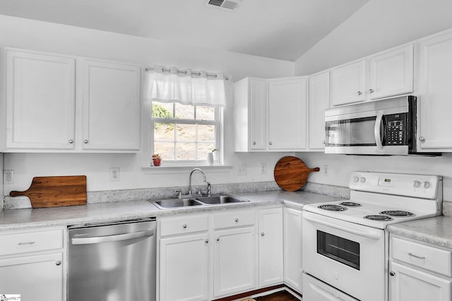 kitchen featuring stainless steel appliances, a sink, and white cabinetry