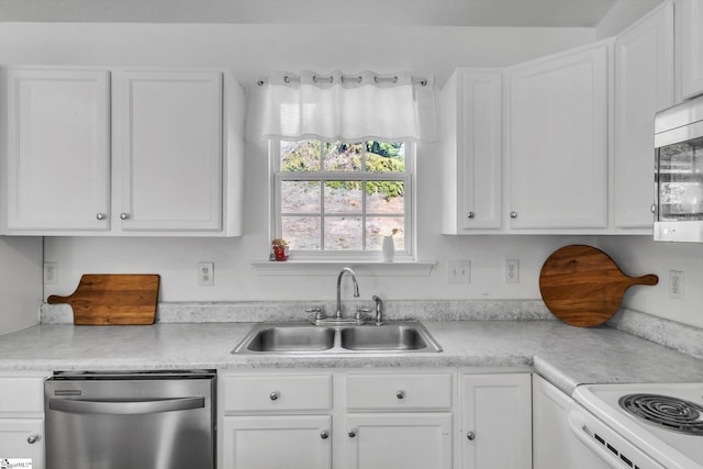 kitchen with stainless steel appliances, light countertops, white cabinets, and a sink