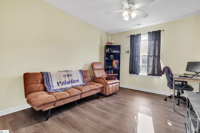 office space featuring ceiling fan, visible vents, baseboards, and wood finished floors