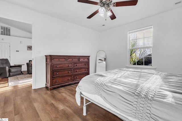 bedroom with visible vents, dark wood finished floors, and a ceiling fan