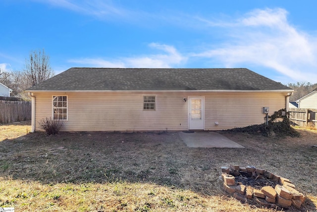 rear view of property with an outdoor fire pit, a patio area, and fence