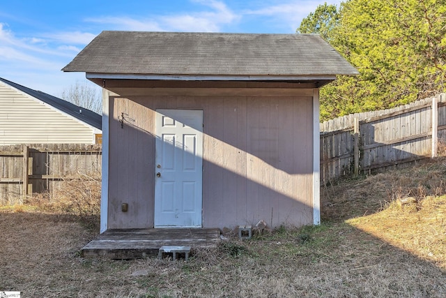 view of shed featuring fence