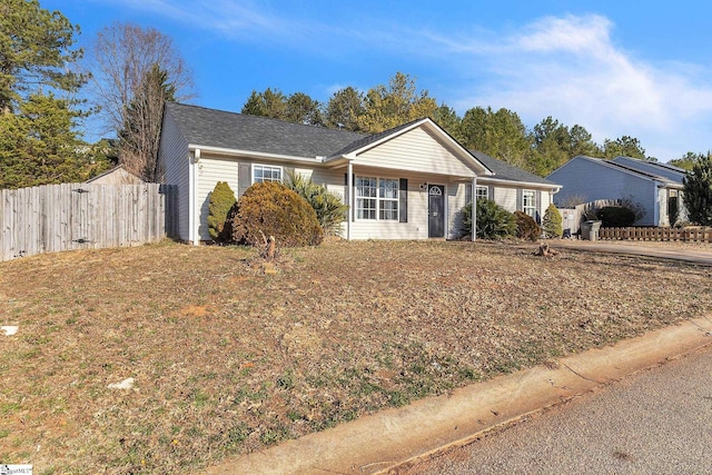 ranch-style home with fence