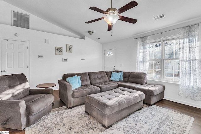 living area with lofted ceiling, a ceiling fan, visible vents, and wood finished floors