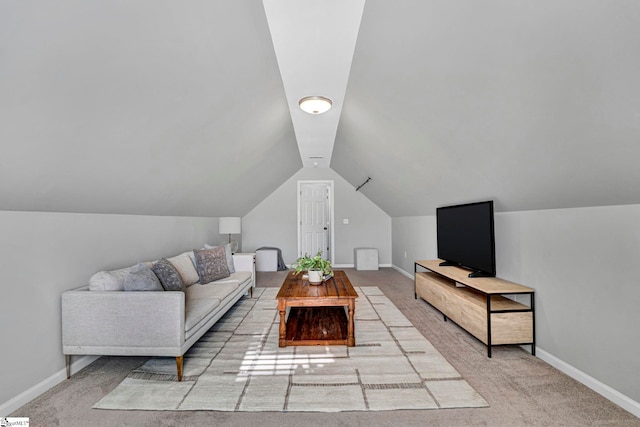 living area with lofted ceiling, carpet, and baseboards