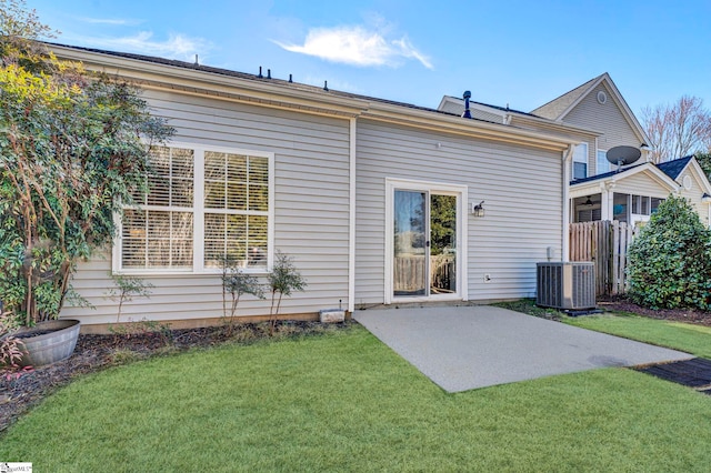 back of house with a patio area, a lawn, and cooling unit