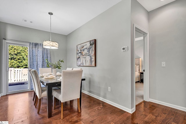 dining area with wood finished floors, visible vents, and baseboards