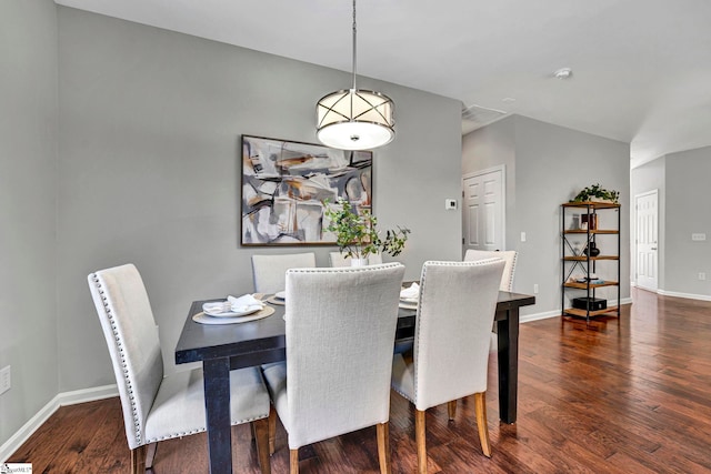 dining room with baseboards and wood finished floors