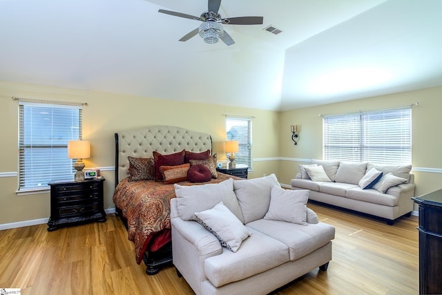 bedroom featuring light wood-style floors, visible vents, vaulted ceiling, and multiple windows