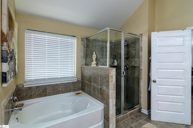 bathroom featuring a stall shower, a garden tub, and tile patterned floors