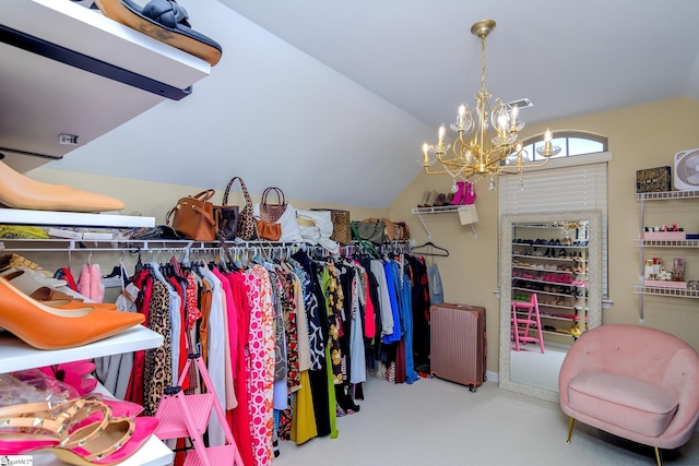 walk in closet featuring an inviting chandelier and vaulted ceiling