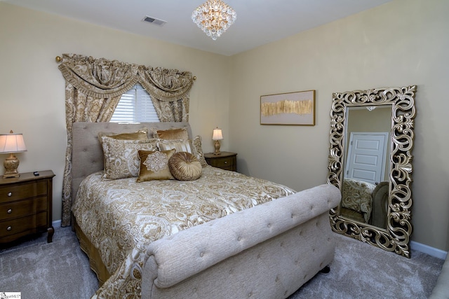 carpeted bedroom with a chandelier, visible vents, and baseboards