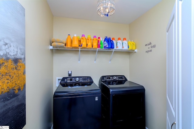 washroom featuring laundry area, a chandelier, and washer and dryer