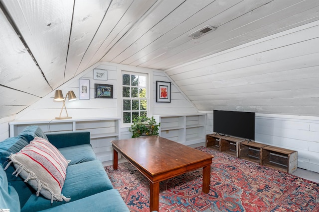 living area with vaulted ceiling, wood ceiling, visible vents, and wood walls