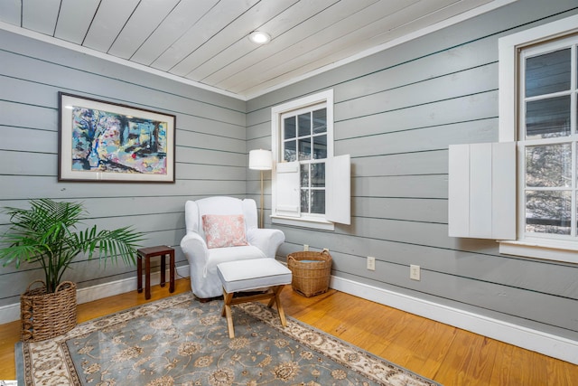 sitting room featuring wooden ceiling, baseboards, and wood finished floors