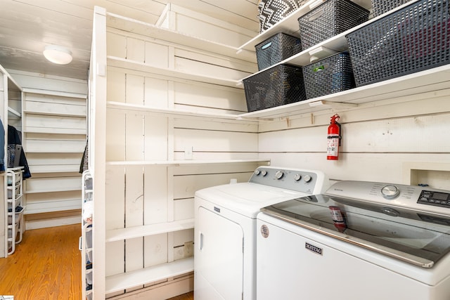 washroom featuring laundry area, light wood-type flooring, and washer and dryer