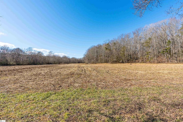 view of landscape featuring a wooded view