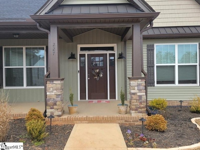 view of exterior entry featuring metal roof and a standing seam roof