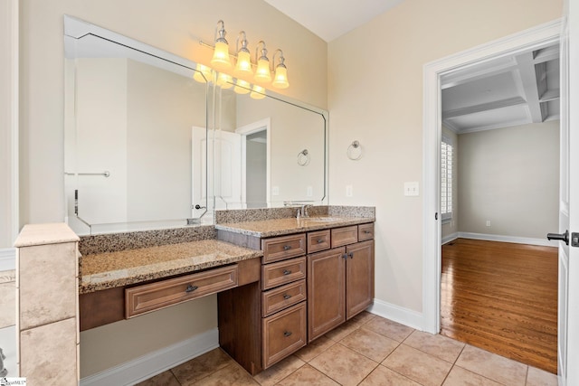 bathroom featuring beam ceiling, vanity, coffered ceiling, baseboards, and tile patterned floors