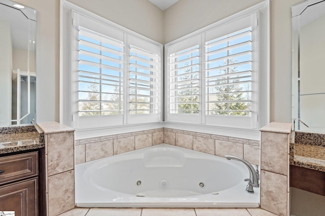 full bath with a whirlpool tub and vanity