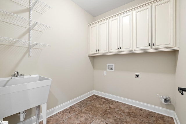 laundry area with hookup for a washing machine, cabinet space, a sink, electric dryer hookup, and baseboards