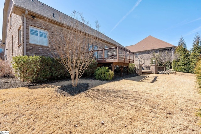 rear view of property featuring a deck