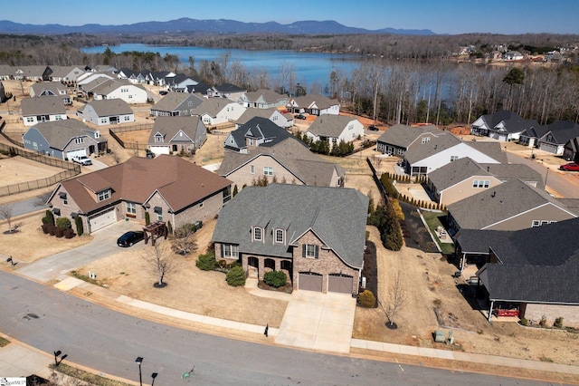 aerial view featuring a water and mountain view and a residential view