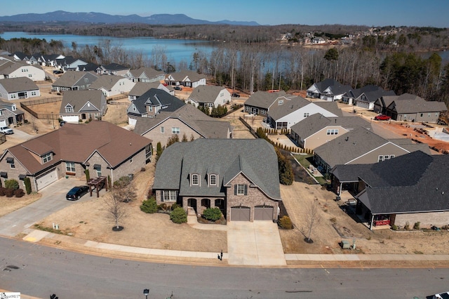 drone / aerial view with a residential view and a water and mountain view