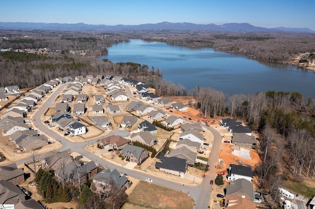 aerial view with a water and mountain view and a residential view