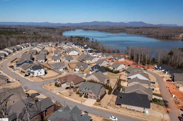 aerial view with a water and mountain view and a residential view