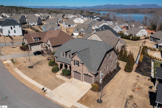 birds eye view of property with a mountain view and a residential view