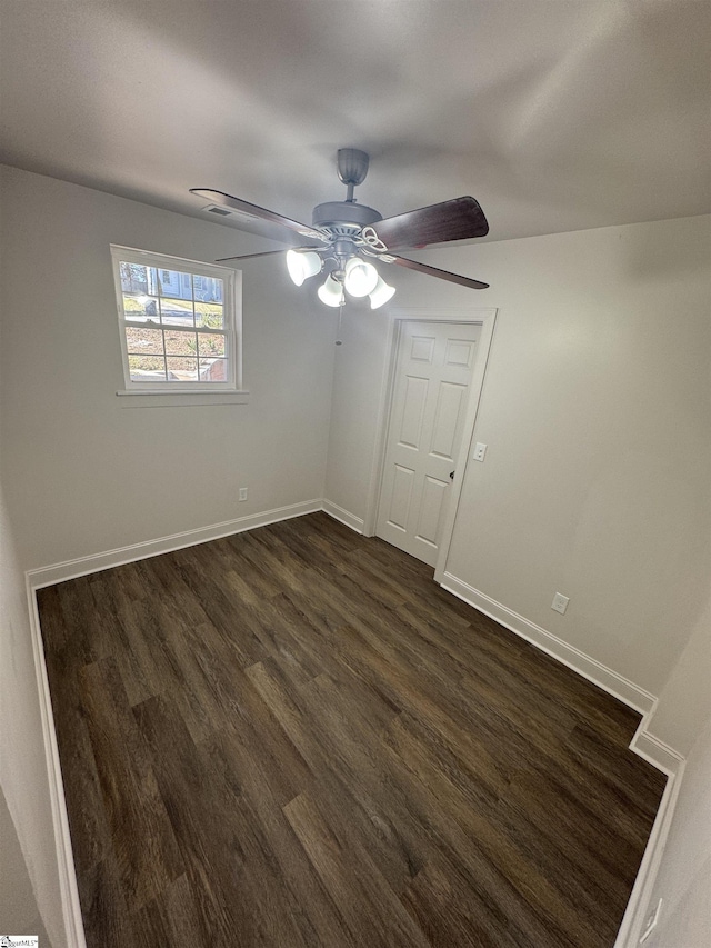 unfurnished bedroom with dark wood-style floors, baseboards, and a ceiling fan