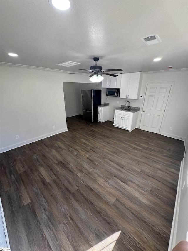 kitchen featuring dark wood-style floors, appliances with stainless steel finishes, open floor plan, white cabinetry, and ceiling fan