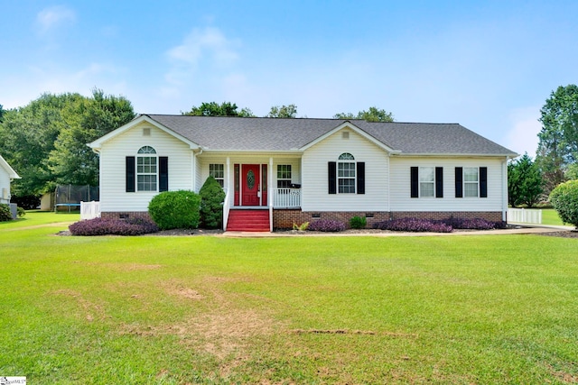 single story home featuring crawl space, a shingled roof, a trampoline, and a front yard