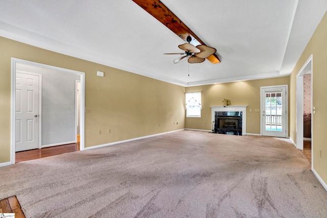 unfurnished living room featuring carpet floors, a healthy amount of sunlight, and a fireplace