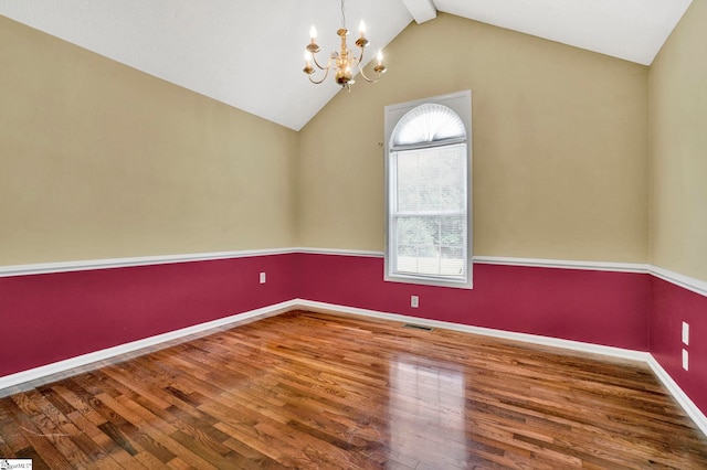 empty room featuring lofted ceiling with beams, an inviting chandelier, visible vents, and wood finished floors