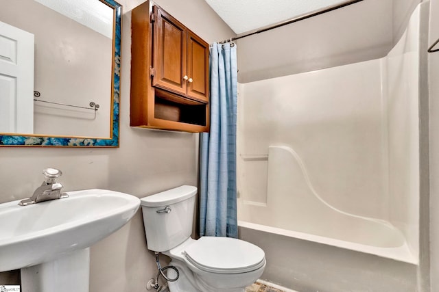 full bathroom featuring toilet, shower / bathtub combination with curtain, and a sink